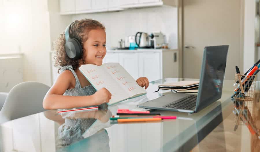 Young girl smiles during remote learning class